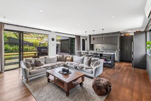 A modern living room with a sectional sofa, a coffee table, and a furry rug.