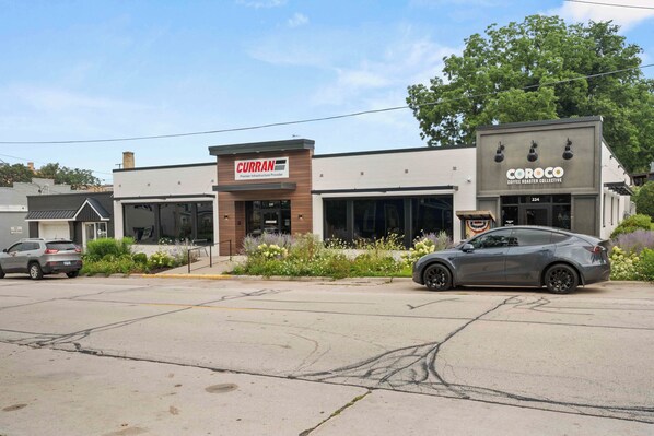 A building with a storefront for CURRAN and a coffee shop named COROCO.