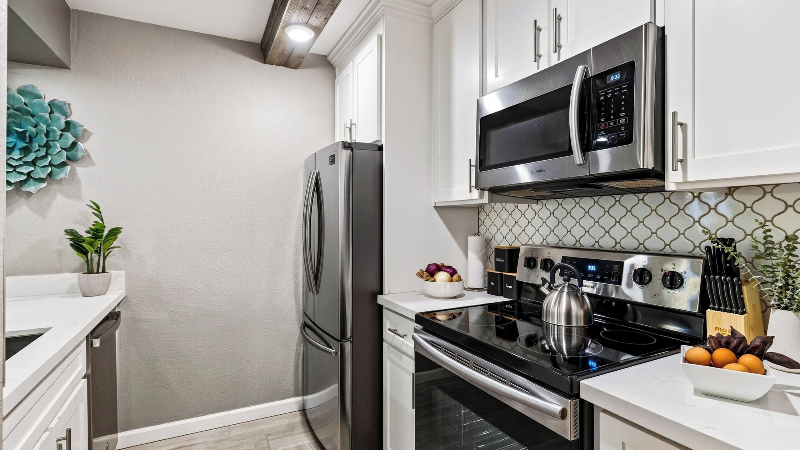 A modern kitchen with stainless steel appliances, a microwave, and a stove.