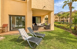 A hotel exterior with a covered outdoor seating area, a pool, and a well-maintained lawn. - Beautiful apartment in San Javier with WiFi (San Javier)