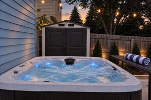 A hot tub with a wooden deck and a wooden fence in the background. - Pool, Hot tub and Gameroom! (Columbus)