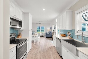 A modern kitchen with white cabinetry, a built-in oven, and a microwave. - Waterfront 2BR, 2BA Islamorada retreat with pool, hot tub, and kayaks. (Islamorada)
