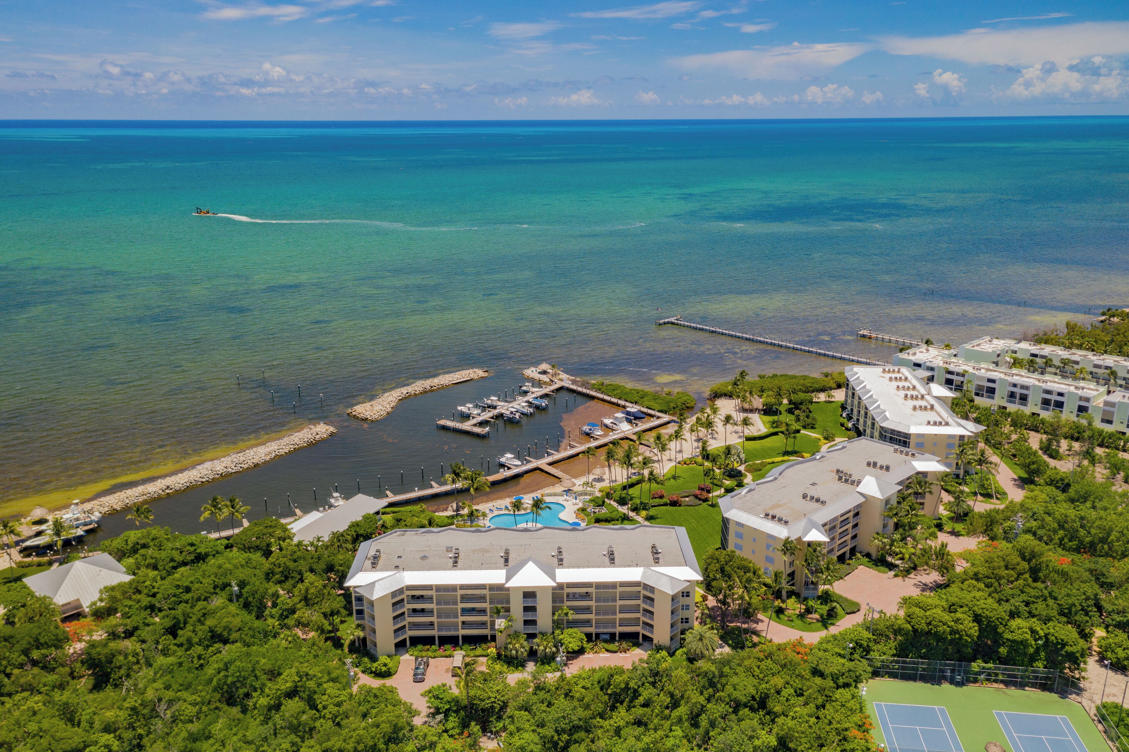 A resort with a marina, swimming pool, and multiple buildings.