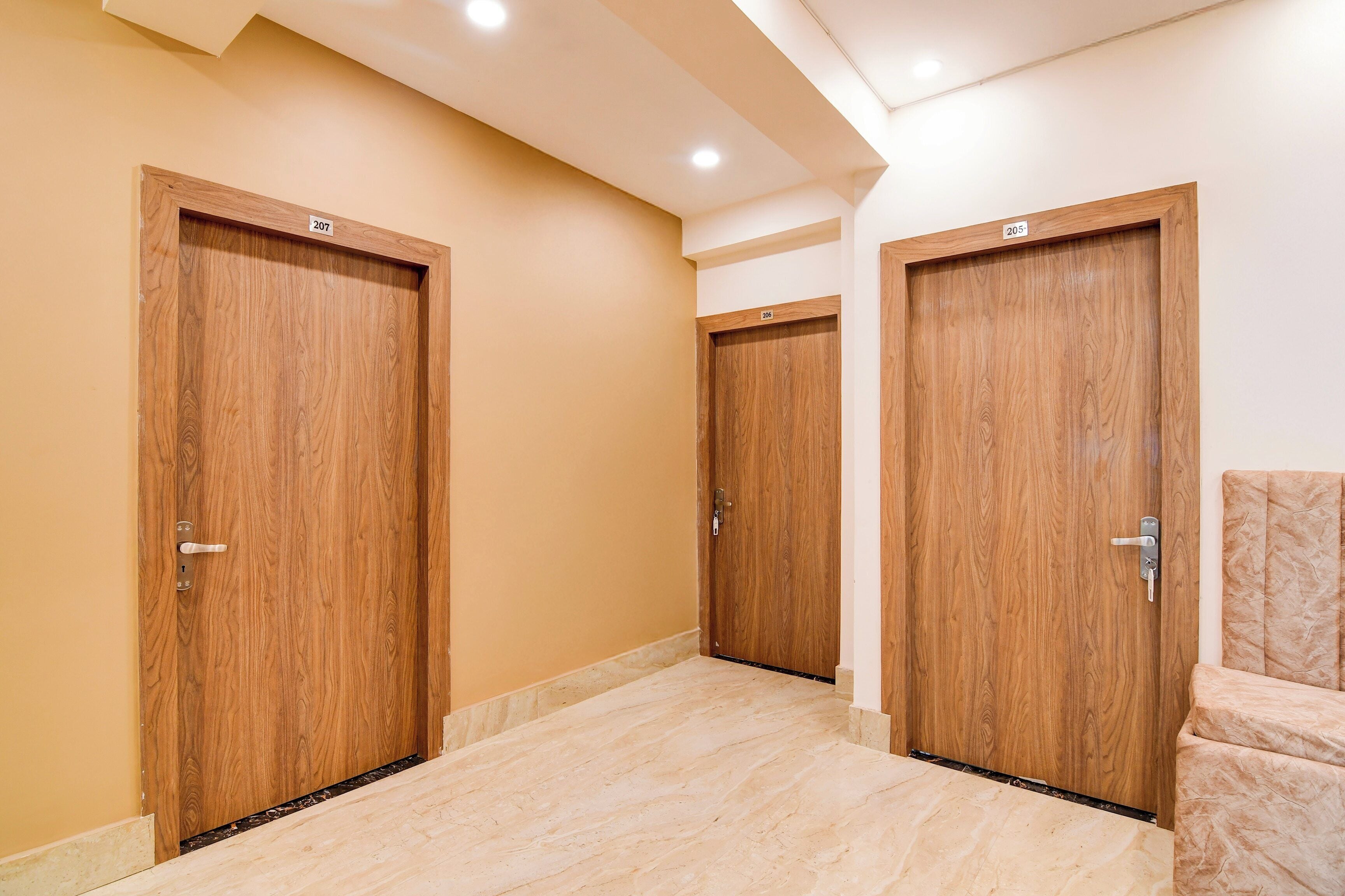 A hallway with three wooden doors, each marked with a number.