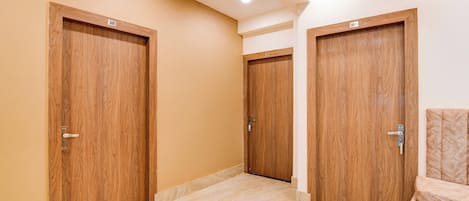 A hallway with three wooden doors, each marked with a number.