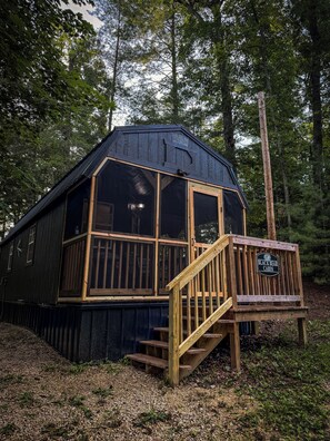 A cabin with a wooden deck and stairs leading to a covered porch. - Escape to Black Bear Cabin near Red River Gorge, your private woodland retreat. (campton)