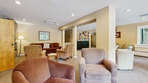 A hotel lobby with seating, a reception desk, and framed pictures on the walls. - Four Season Connecting Condos:  seasonal pool, ski, hike & golf (Warren)