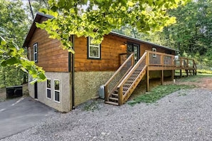 A wooden cabin with a covered porch and a staircase leading to a deck. - Endless MTN Escape: Spacious, Hot Tub, MORE GAMES! (Sevierville)