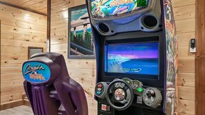 A wooden cabin interior with a gaming console featuring a 'Cruisin' Exotic' theme. - Endless MTN Escape: Spacious, Hot Tub, MORE GAMES! (Sevierville)