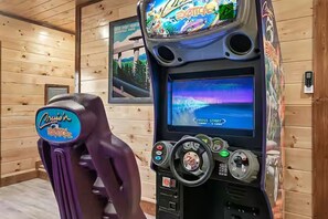 Ein Holzhütten-Innenraum mit einer Spielkonsole, die das Thema 'Cruisin' Exotic' zeigt.