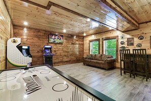 A wooden interior with a pool table, a sofa, and a bar area. - Endless MTN Escape: Spacious, Hot Tub, MORE GAMES! (Sevierville)