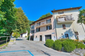 A two-story building with a balcony and a garage.