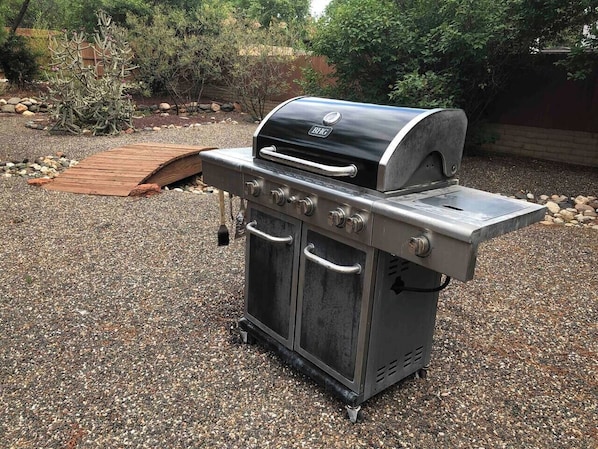 A portable outdoor grill with a built-in smoker, a side burner, and a storage cabinet. - Luxe Couples Retreat—Indoor Spa * 4 King En-Suites (Sedona)