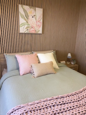 A bed with a textured green bedspread, multiple pillows, and a knitted throw. - Just Opened! The Nest at Forest Lake - Stylish Guest Suite (Kangaroo Flat)