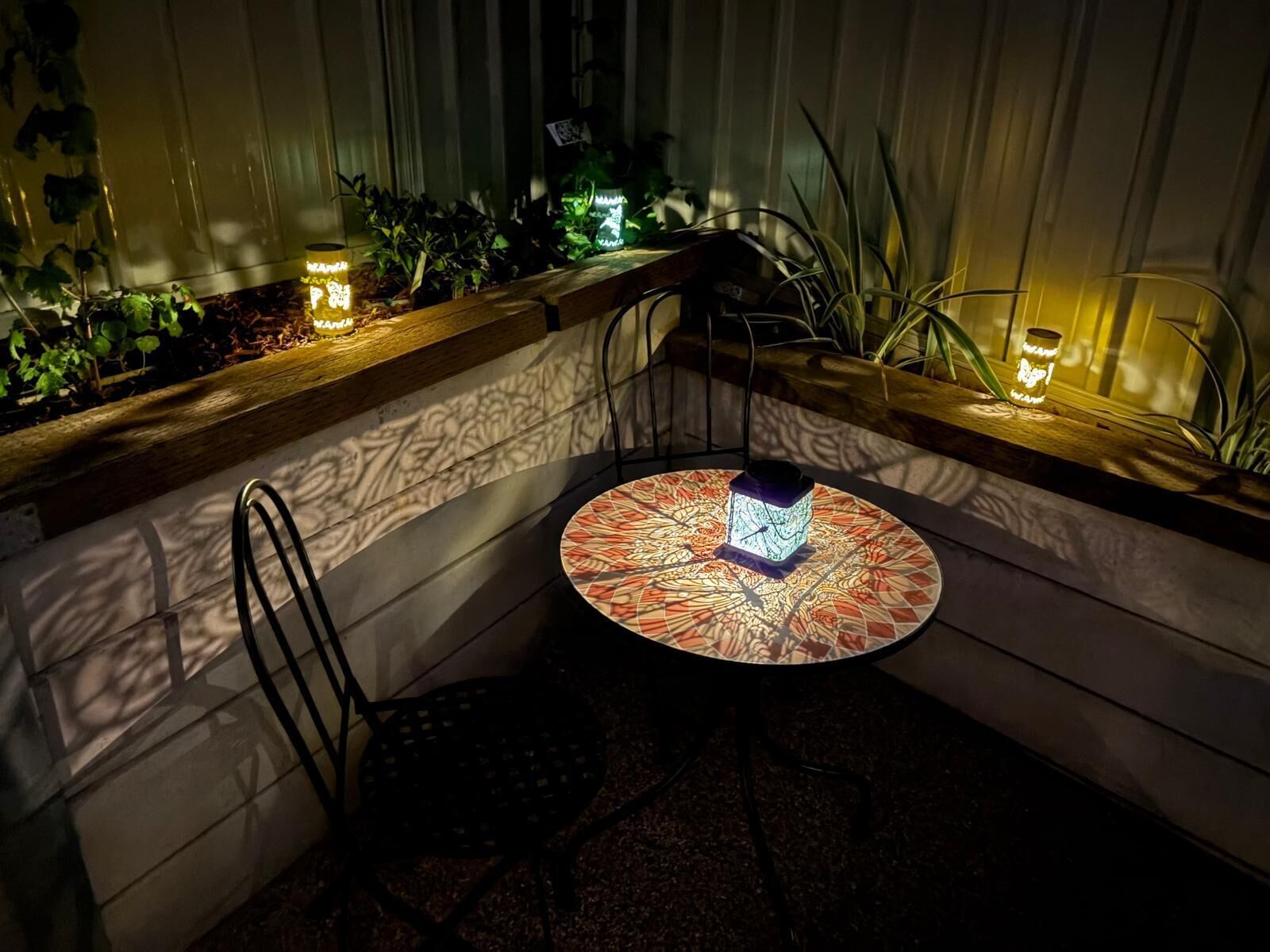 A corner seating area with a round table, a chair, and a decorative box.
