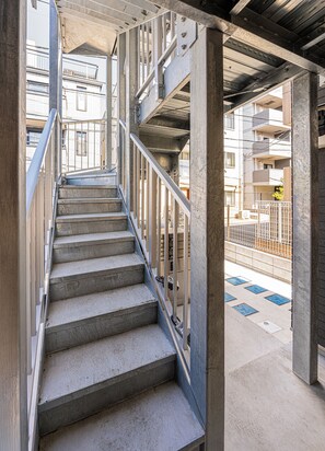 A concrete staircase with metal railings leading to an upper level. - The Parknest Haneda (Tokyo)