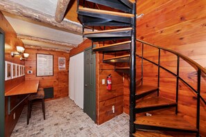 Spiral staircase leading to the downstairs bedrooms, spacious hallway, and laundry area. - Sunsky at Skyforest - Lake View, Large Deck, Pets (Lake Arrowhead)