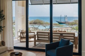 The second-floor living room offers a comfortable spot to relax while enjoying the beautiful Caribbean Sea view - New Oceanfront LUX 5BR Pool · Sunset Cove Malmok (Noord)