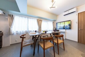 A modern dining area with a table, chairs, and a television on the wall. - June 2025 open! 3LDK/ Center of Shinsaibashi, Go Namba! (大阪市西区北堀江１丁目)