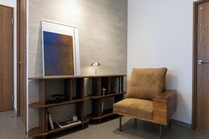 A modern room with a wooden chair, a bookshelf, and a framed abstract artwork. - June 2025 open! 3LDK/ Center of Shinsaibashi, Go Namba! (大阪市西区北堀江１丁目)