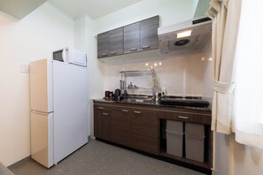 A compact kitchen with a refrigerator, microwave, and a sink area. - June 2025 open! 3LDK/ Center of Shinsaibashi, Go Namba! (大阪市西区北堀江１丁目)
