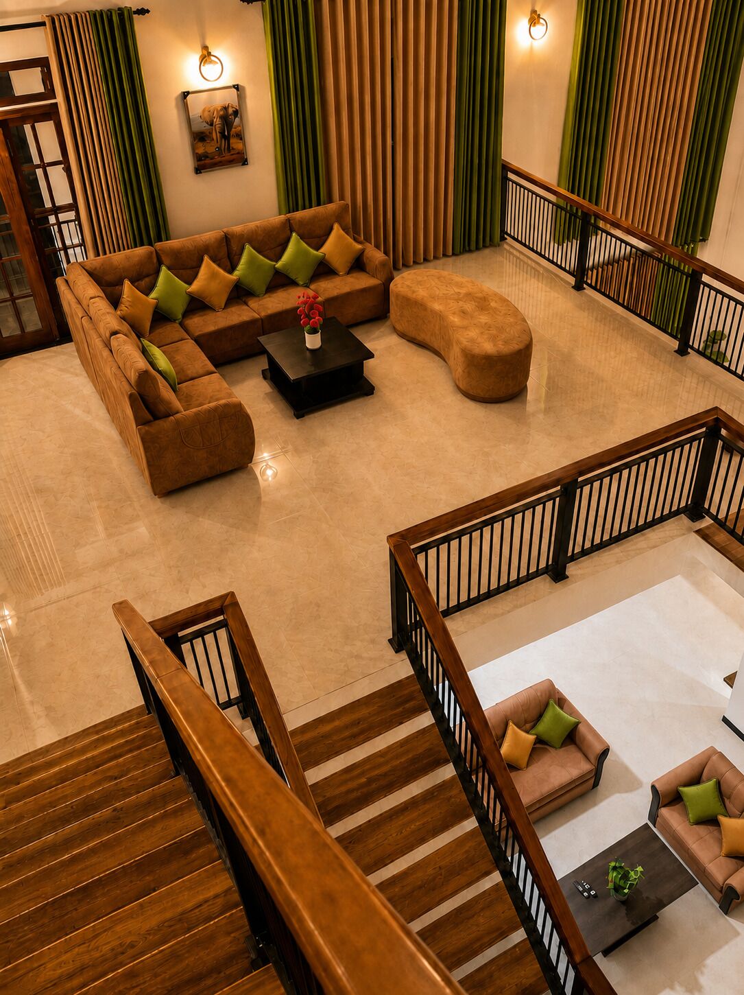 A spacious living area with a sectional sofa, ottoman, and coffee table, a staircase with wooden railings, and a view of the outside through large windows.