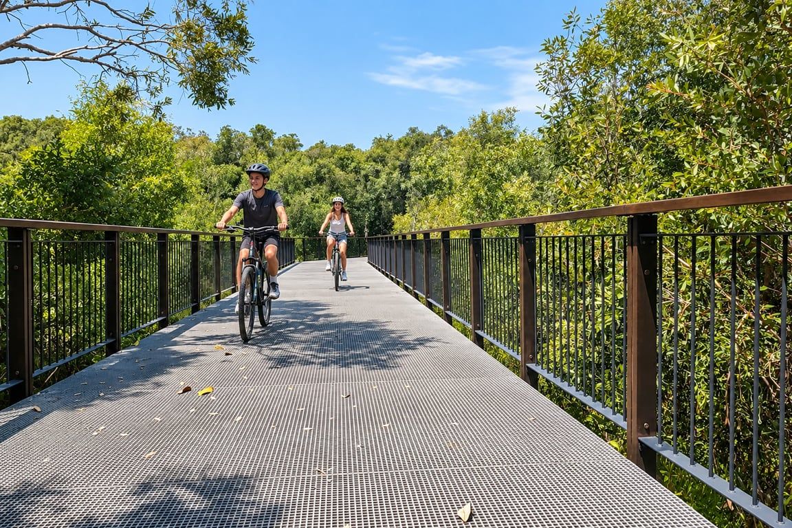 A metal bridge with a grid pattern, surrounded by greenery.