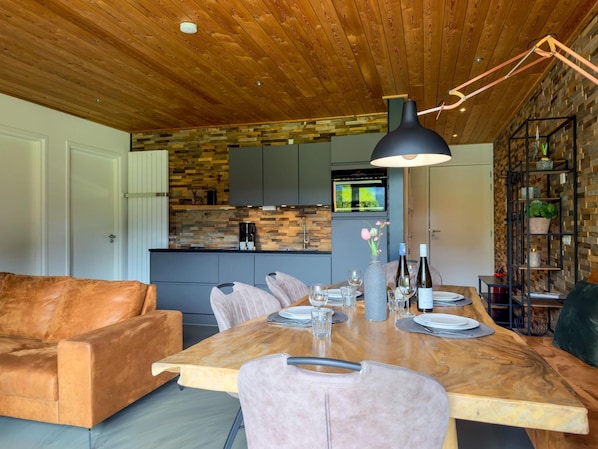 A modern kitchen with a stone backsplash, wooden cabinets, and a built-in oven.