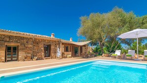 A stone building with a pool, outdoor seating, and trees. - Es Tancat Prim - Villa With Private Pool (Algaida)