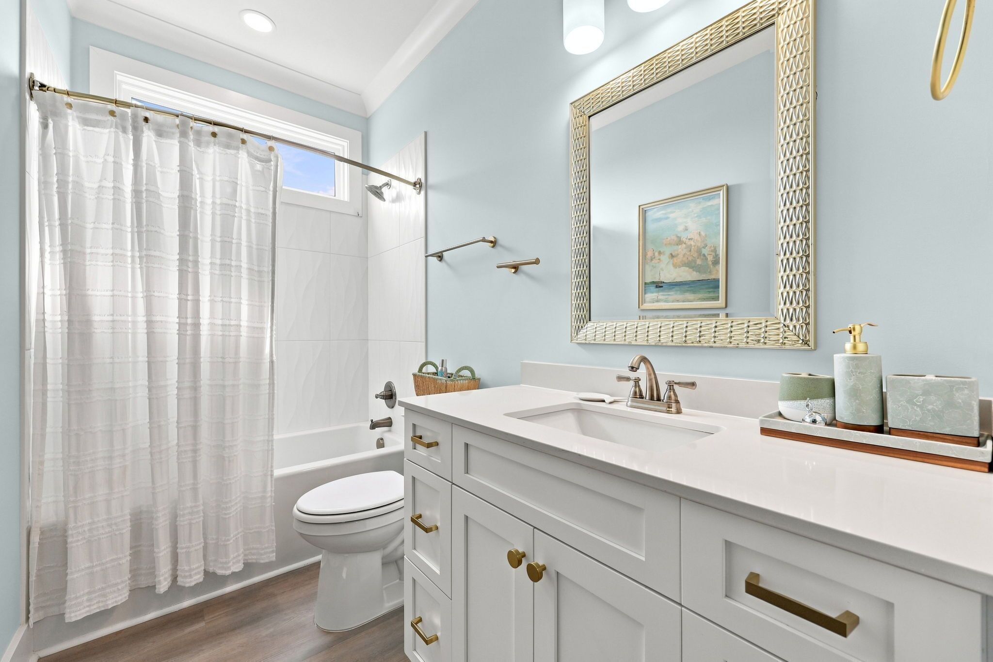 A bathroom with a bathtub, toilet, and sink.