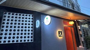 A building with a modern facade, a gated entrance, and a sign indicating a home or residential area. - Ala Homestay Can Tho - Vincom Xuan Khanh (Can Tho)