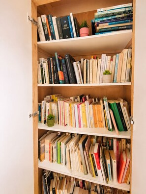 A bookshelf with multiple shelves filled with books.