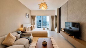 A modern living room with a sofa, coffee table, and a television. - Vanilla Homes Premium Studio the Arc Reem Island (Abu Dhabi)