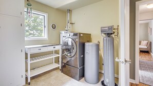 A laundry room with a washing machine, dryer, and water heater. - Updated Home Minutes to Downtown and Beach! (Sister Bay)