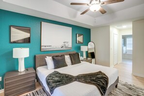 A bedroom with a bed, nightstands, a ceiling fan, and artwork on the walls. - 4 Mi to River & Gardens! Quiet Port St Lucie Home (Port St. Lucie)