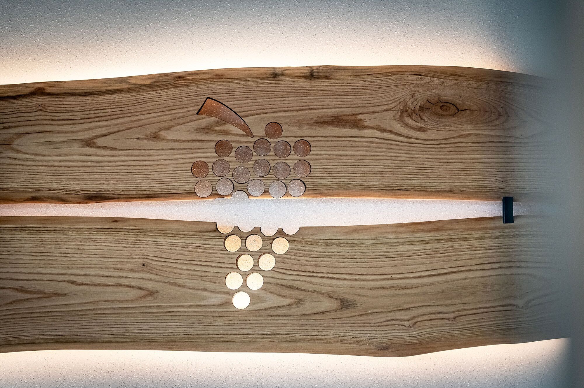 A wooden surface with a series of circular objects arranged in a descending pattern.