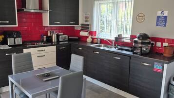 Coffee/tea maker, fridge, cookware/dishes/utensils