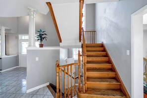 A staircase with wooden steps and a wooden railing. - King Bed, Home Gym, 4 TVs, Near Recreational Parks, Tennis Court, Shops! (Ajax)