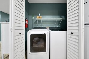 A laundry room with two dryers, a shelf with a basket and a bottle, and a fire extinguisher. - 5 Mi to 3 Sisters Springs! Unit w/ Boat Parking (Homosassa)
