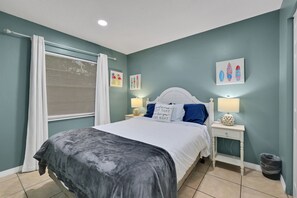 A bedroom with a bed, nightstands, and wall art. - 5 Mi to 3 Sisters Springs! Unit w/ Boat Parking (Homosassa)