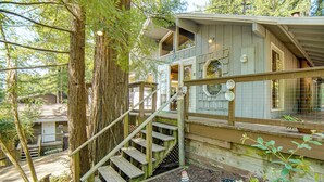 A wooden staircase leading to a house with a balcony, surrounded by trees. - Walk to Beach! Home w/ Sunroom in Anchor Bay (Gualala)