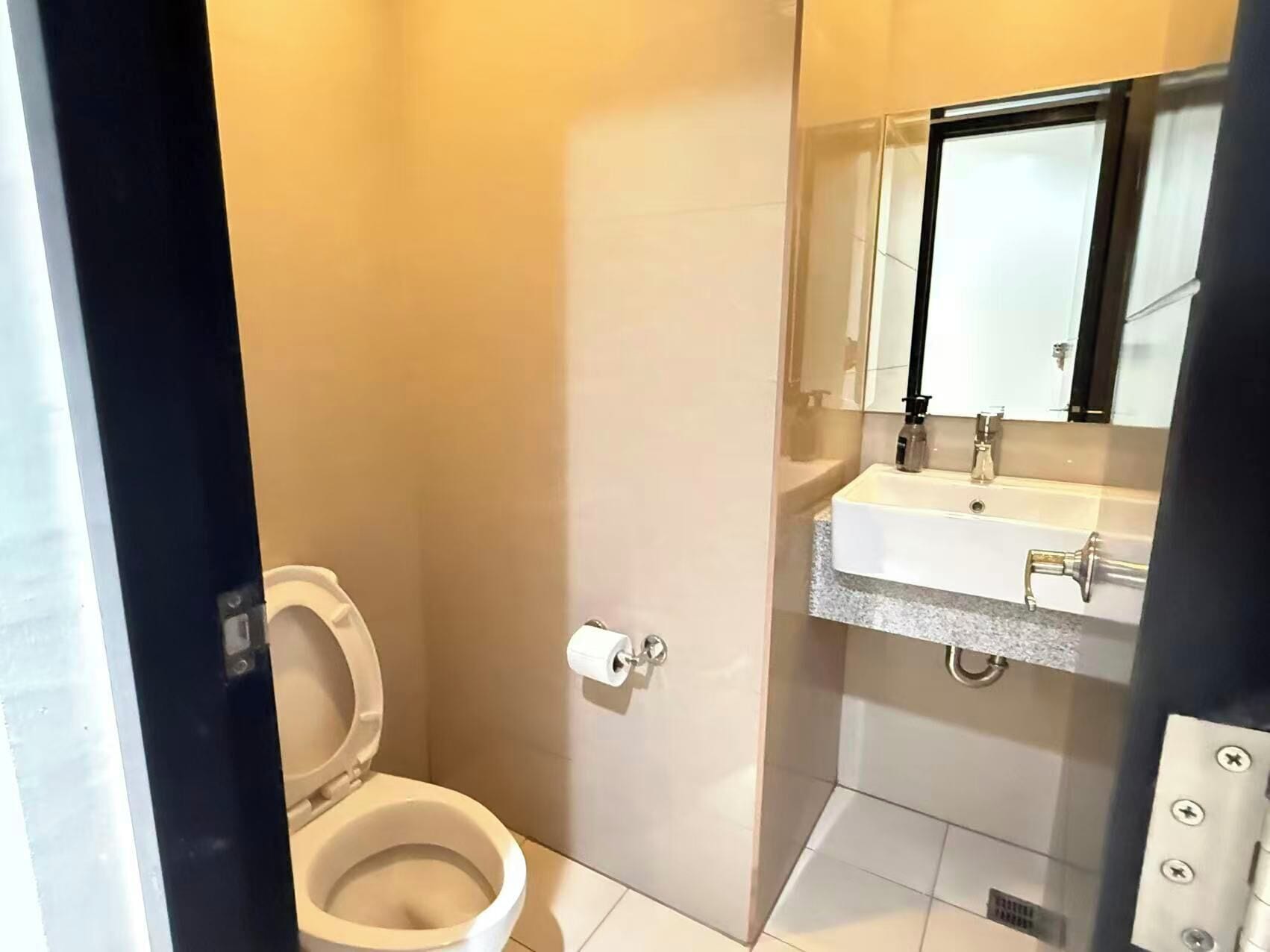 Baño con inodoro, lavabo y espejo.