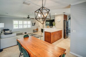 A modern kitchen with a wooden dining table, a built-in oven, and a large island. - Quiet Home 1 Mi to Savannas Preserve State Park! (Port St. Lucie)