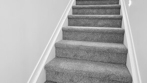 A staircase with carpeted steps and a metal handrail. - Waipuna Living | 3-Bed Townhouse | Spacious Home (Mount Wellington)