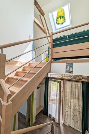 A wooden staircase leading to a bunk bed area with a skylight above. - Gîte 2 "Le Bateau Yves" by Interhome (Blainville-sur-Mer)