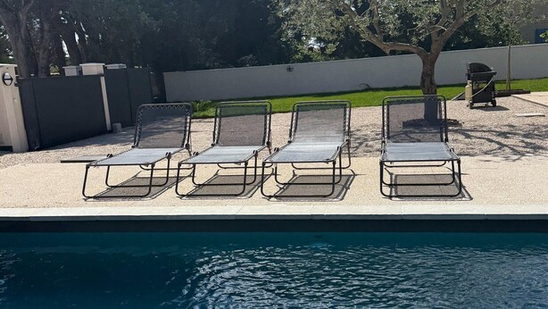 A poolside area with four lounge chairs and a barbecue grill. - Villa with pool and jacuzzi near Châteauneuf-du-Pape – 4 people (Sorgues)