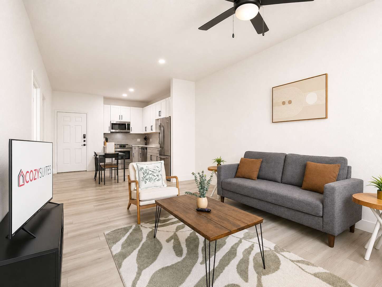 A modern living room with a grey sofa, a wooden coffee table, and a ceiling fan.