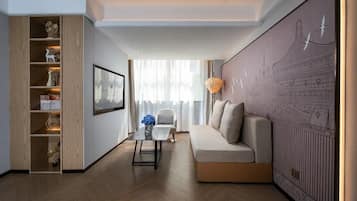 A modern living room with a sofa, a coffee table, and a bookshelf.