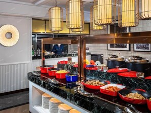 A buffet with various food items and a counter with plates. - Metropolo Changsha Wuyi Square IFS Hotel (Changsha)