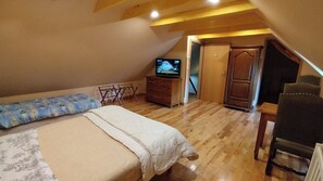 A bedroom with a bed, a dresser, a television, and a chair. - Charmante maison de 4 chambres avec salle de bain privative à Villersexel (Villersexel)